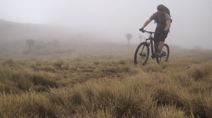 man riding bike in fog