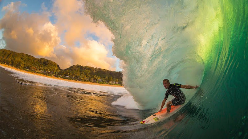 man surfing inside a wave