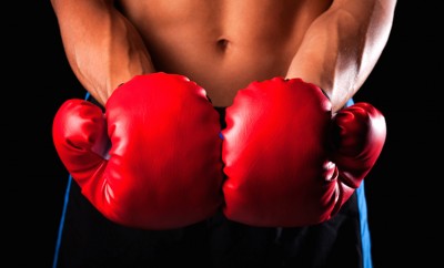 male boxer with red kickboxing gloves