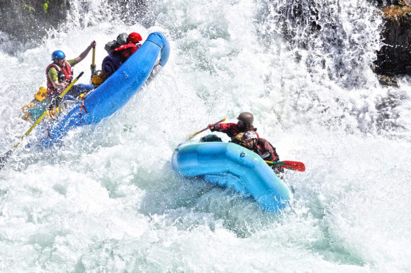 two white water rafters in rough rapids