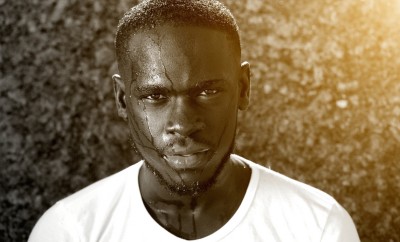 Close up black and white portrait of an african american man dripping with sweat