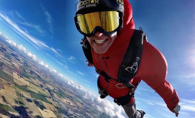 Erik Roner skydiving in red BASE jumping suit