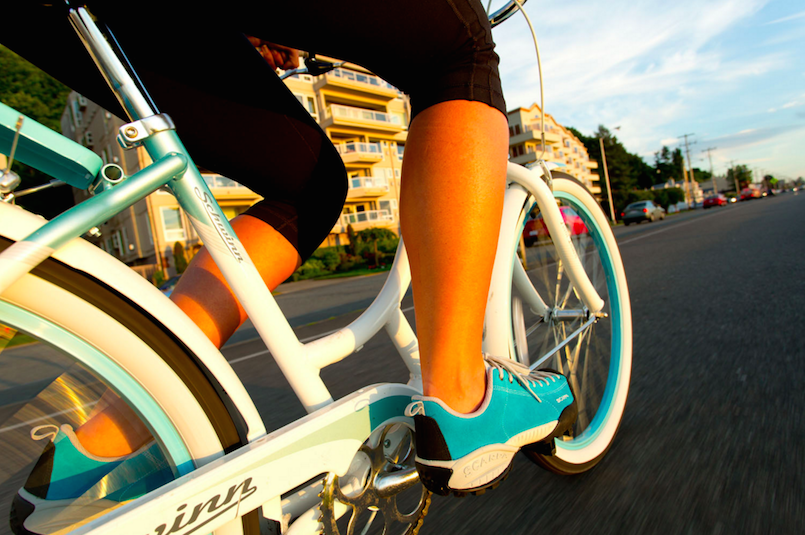 girl calves blue tennis shoes riding bike outside