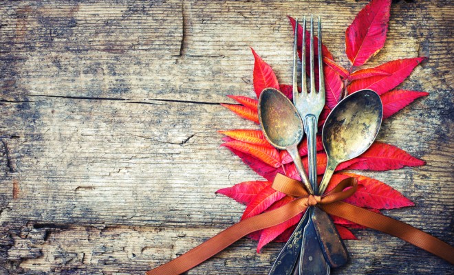 Thanksgiving table setting: cutlery on the autumn background with autumn leaves,ribbon on wooden background:Thanksgiving holidays background concept