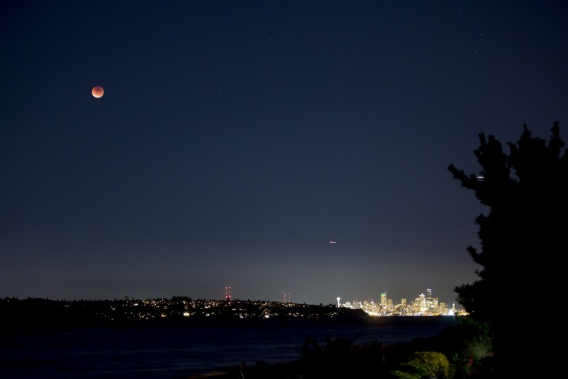 full moon over Seattle city skyline at night