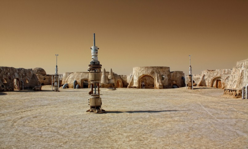 Abandoned sets for the shooting of the movie Star Wars in the Sahara desert on a background of sand dunes