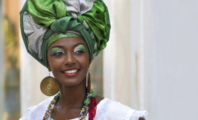 Brazilian woman of African descent, smiling, dressed in traditional Baiana attire in Pelourinho, Salvador, Bahia, Brazil