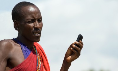 Native Masai with Cellphone in Masai Mara National Park, Kenya
