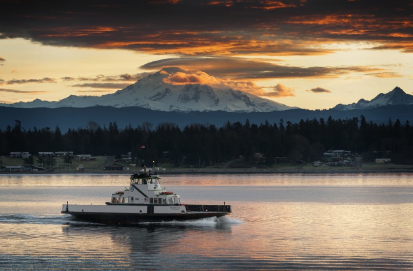 Ferry and Mt. Baker. The ferryboat “Whatcom Chief” sails from Gooseberry Point to Lummi Island across Hales Pass in the San Juan Islands of Puget Sound. Mt. Baker is seen in the background at sunrise.