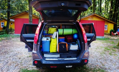 Travel and camping luggage packed in the car trunk. Outdoor wanderlust items. Outdoor, adventures and travel suv