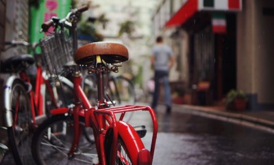 red bike on rainy city street
