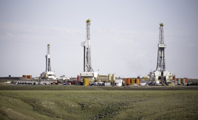 Three hydro-fracking derricks sitting on a plain