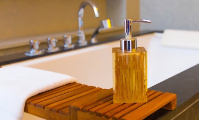 Liquid soap bottle on the bathtub in modern bathroom