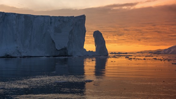 Big iceberg and Midnight sun light on the arctic ocean in Ilulissat, Greenland