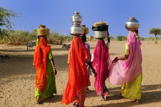 Thar desert near Jaisamler. Ethnic women going for the water in well on the desert. Rajasthan, India