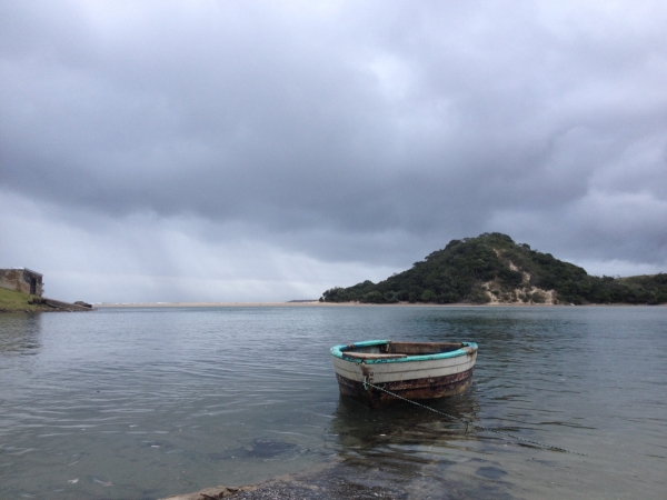 serene-calm-boat-on-water-in-africa-cloudy