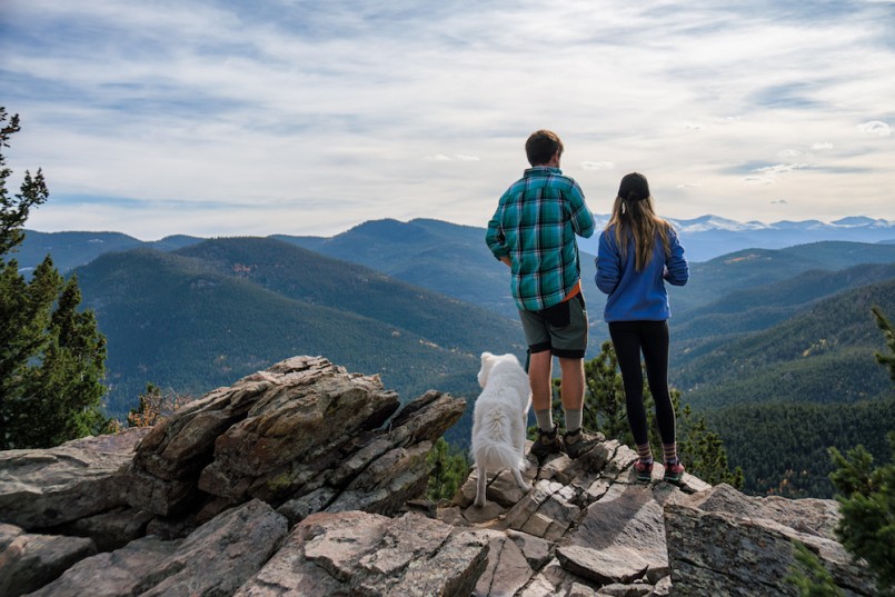 Hinking Couple with dog in the mountains